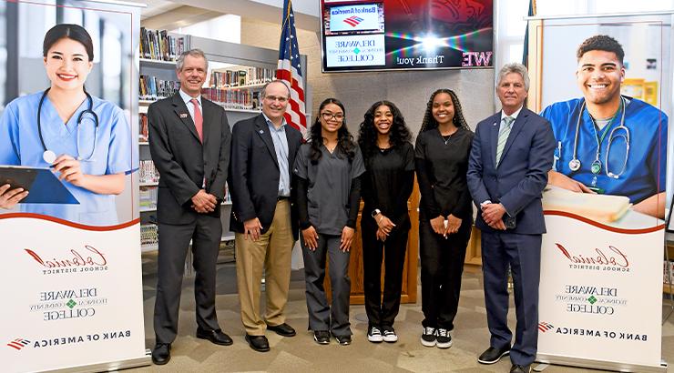 A group of Delaware Tech representatives and William Penn High School students and employees standing in a horizontal line